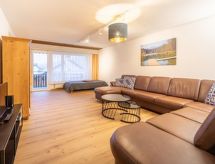 Riant appartement in Laax, direct aan de skipiste met uitzicht op berg en meer - thumbnail 1
