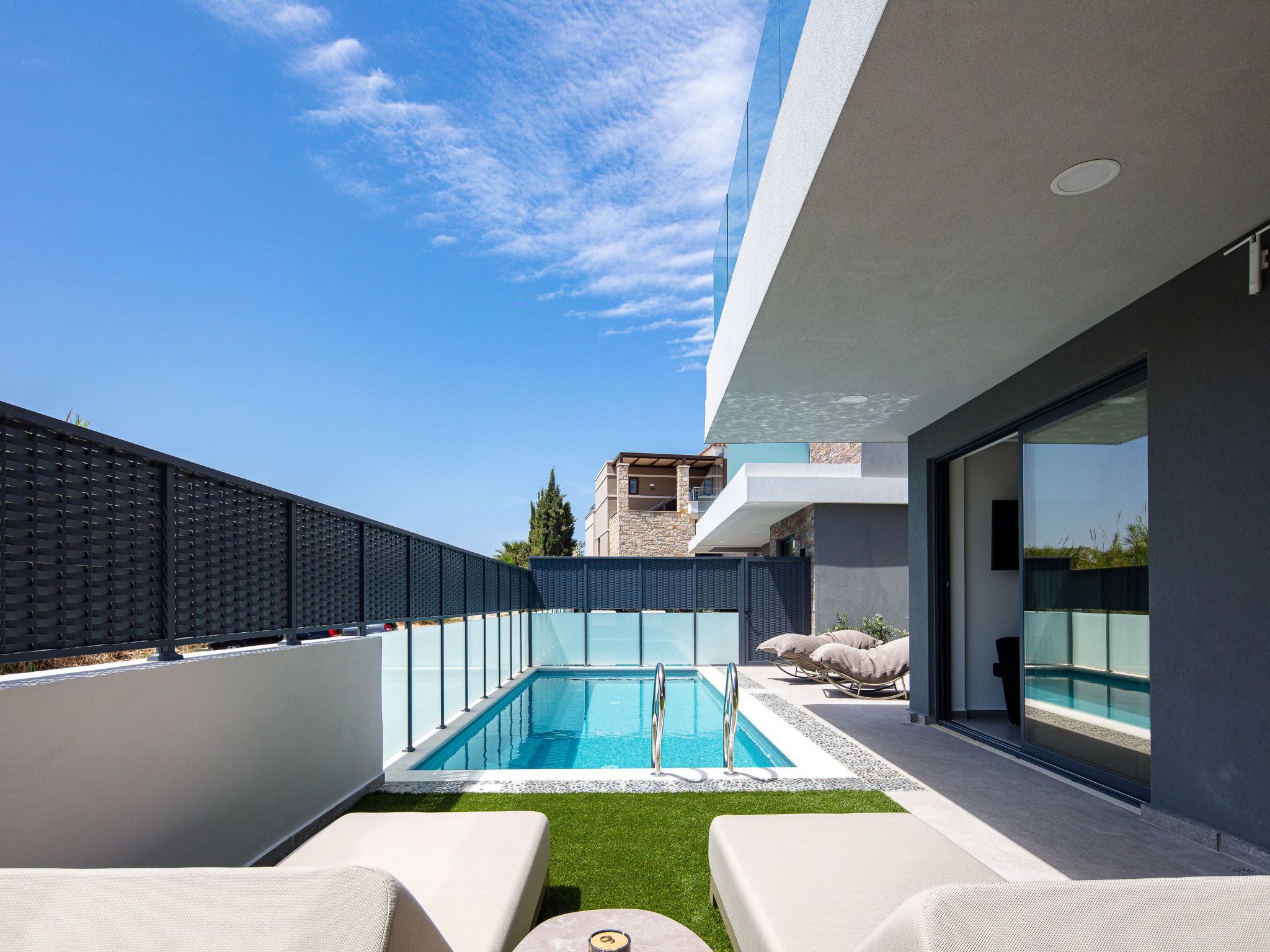 VillaSaints IΙ is a modern two-story luxury villa, designed to offer a serene and stylish escape just moments from the sea. Blending contemporary indoor comforts with elegant outdoor living, this vil..