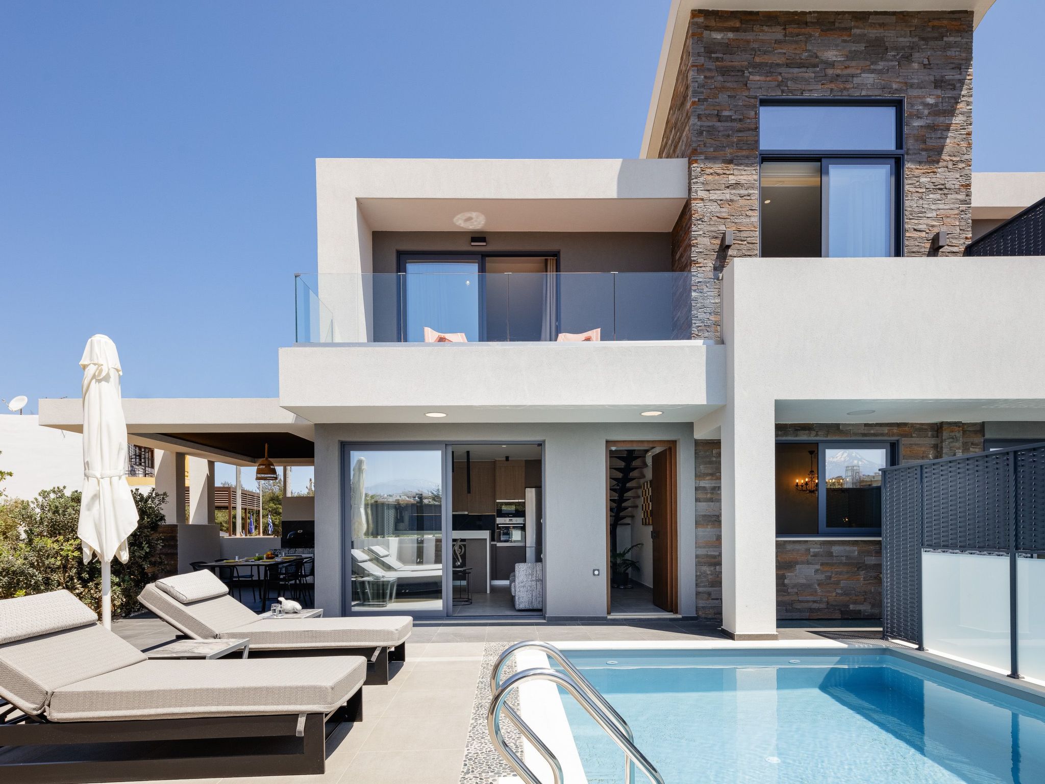 VillAgioi Villa I is a luxury two-story villa located just 450 meters from the sandy beach of Agioi Apostoloi. Ideal for families or small groups, it features a private pool, BBQ area, and open living..