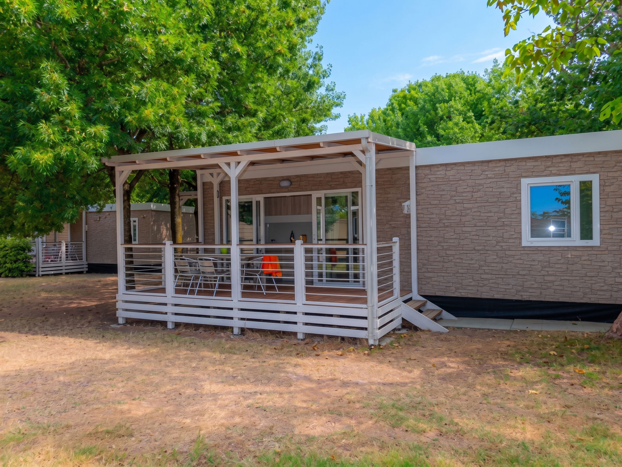"Prestige", 4-kamers mobilhome 33 m2. Comfortabel ingericht: eetkamer met Sat-TV. Uitgang naar het terras. 1 kamer met 1 2-pers bed. 2 kamers, elke kamer heeft 2 bedden. Open keuken (4 inductiekookpla..