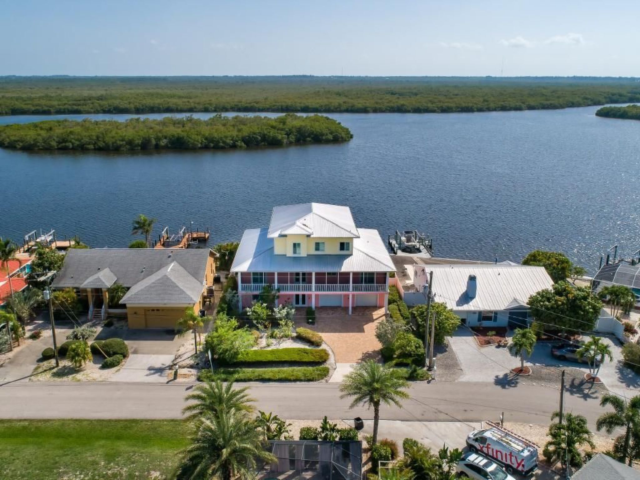 Immerse yourself in the idyllic charm of this three-story Key West style residence, perfectly situated to offer unsurpassed views of the bay. Embrace the essence of Island time in this exquisite water..